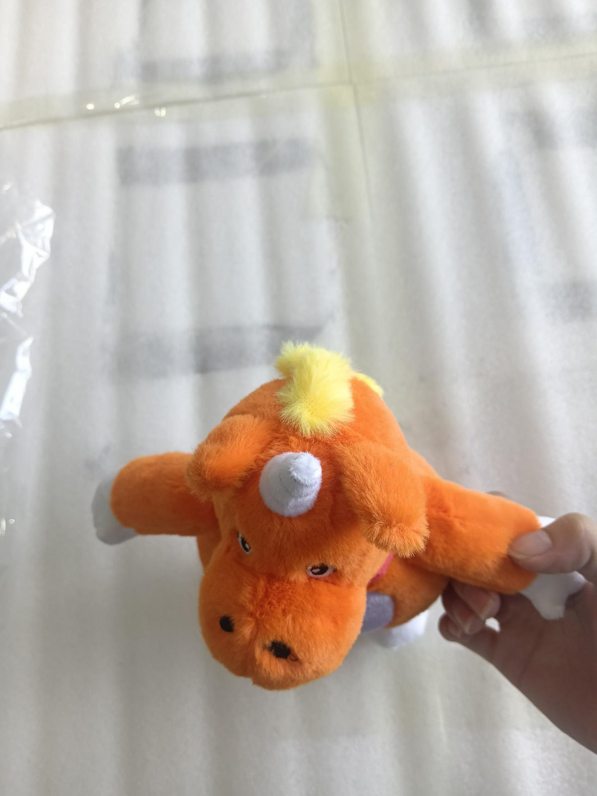 handmade_Buddy_the_Unicorn_plush_toy_standing_25cm_tall_in_bright_orange_supplier_photo.