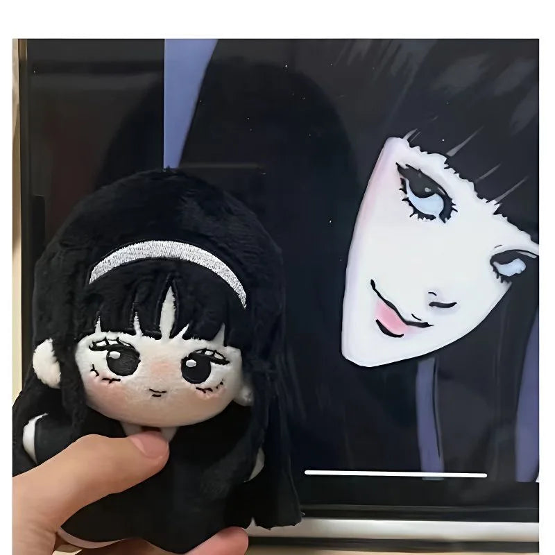 10cm handmade Tomie stuffed toy held in hand showing compact size — lightweight horror plush collectible
