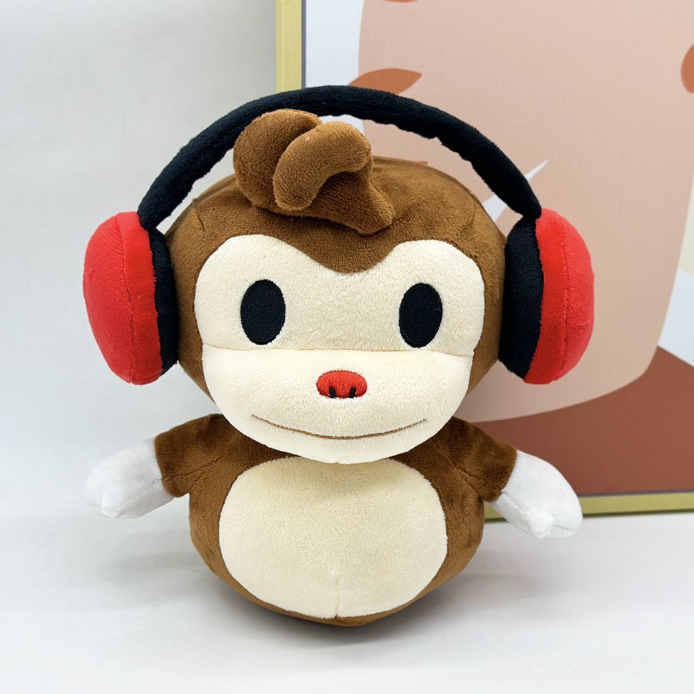 22cm BOMBANANA plush toy sitting on gaming desk