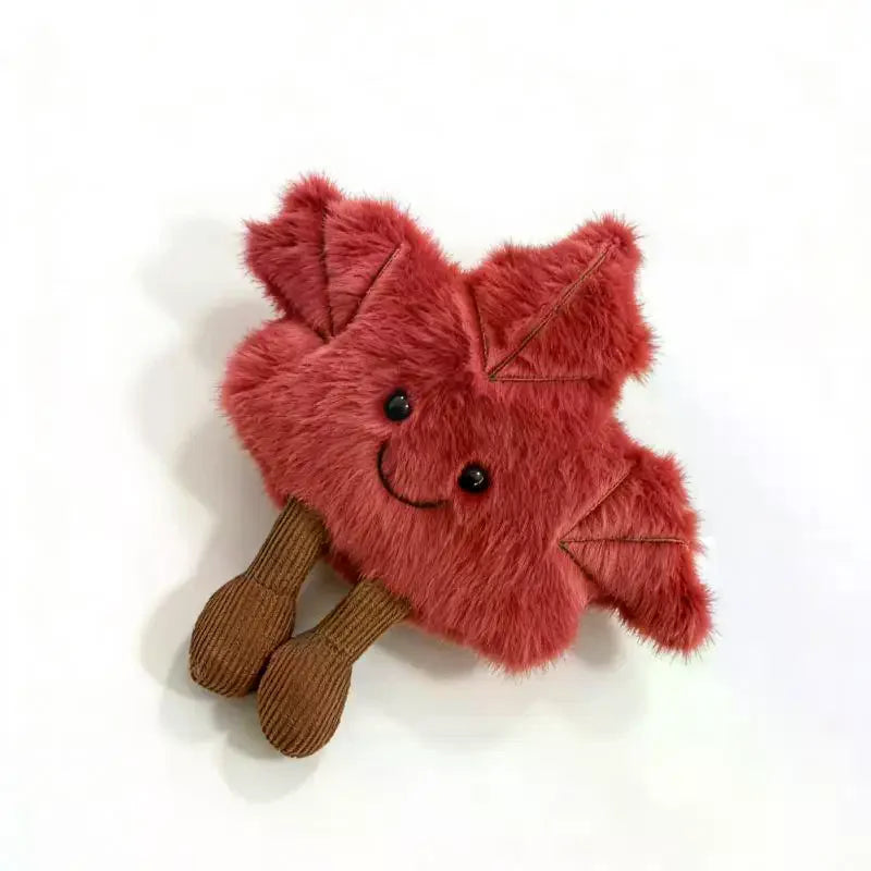 22cm smiling maple leaf plush toy shown next to coffee mug for size reference