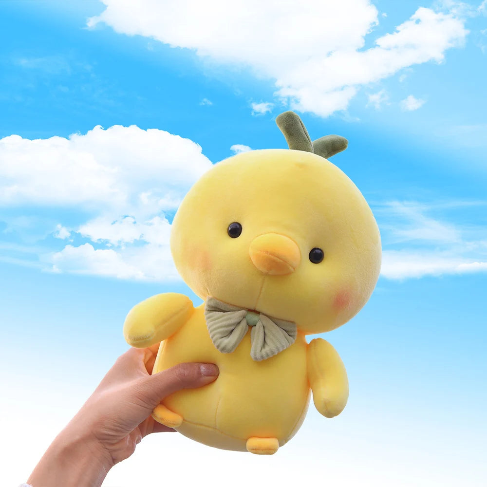 25cm kawaii chick stuffed animal displayed on a wooden shelf next to books