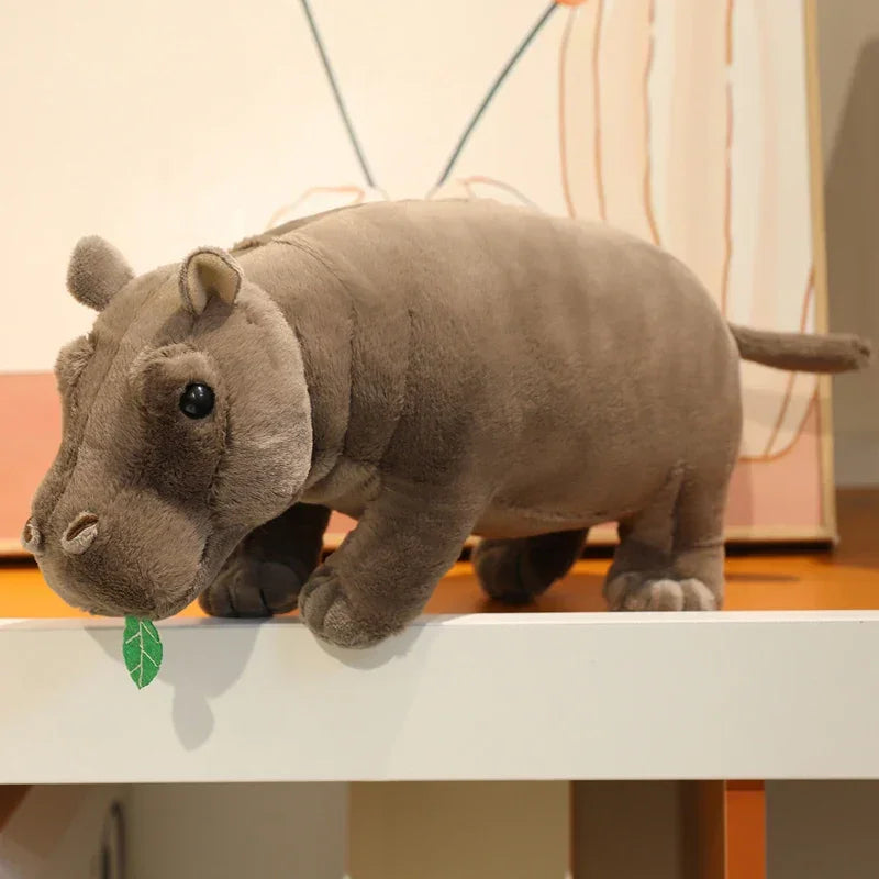 25cm size viral hippo toy next to a coffee mug for scale