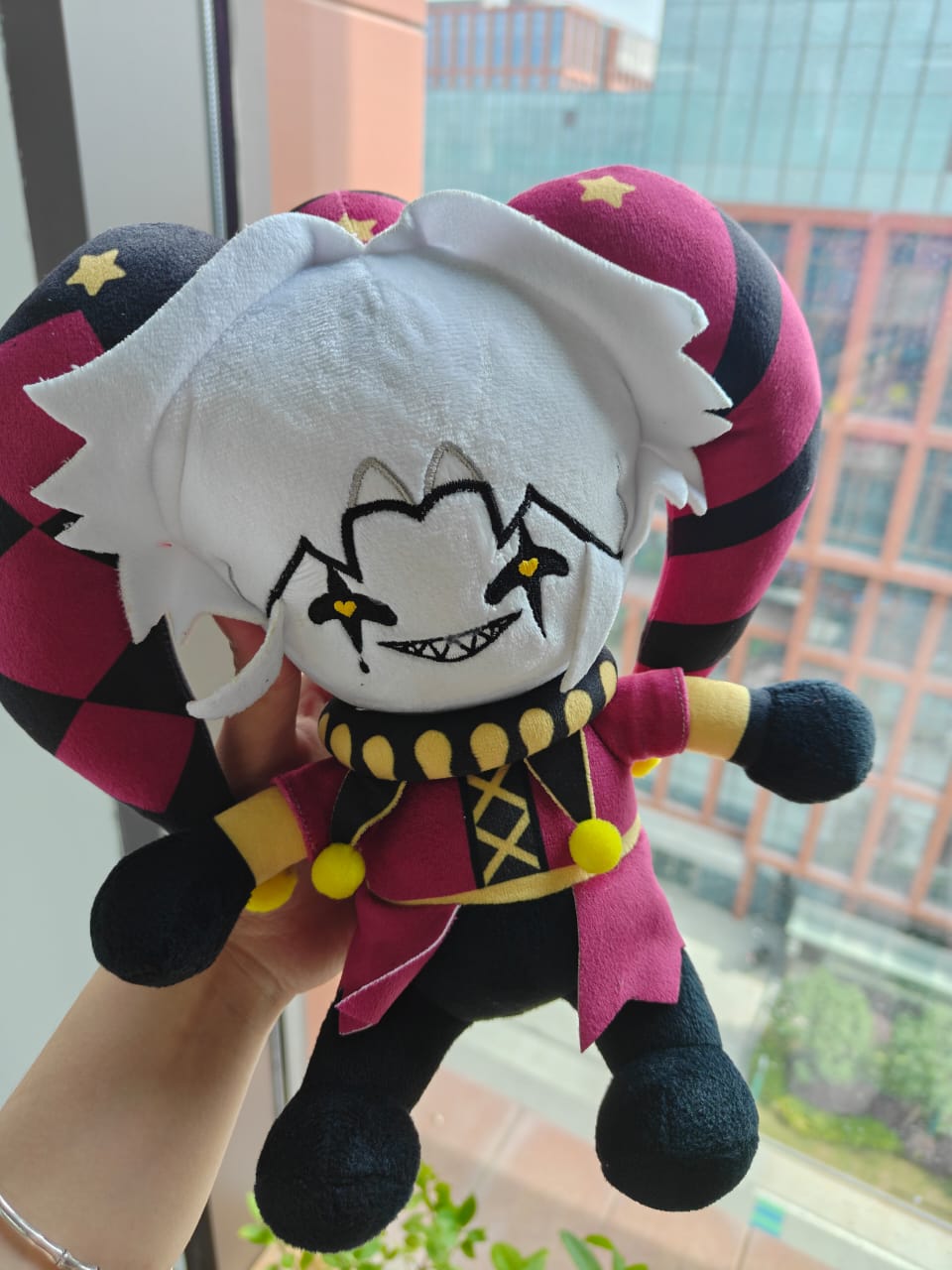 A collectible 25cm handmade circus horror jester plush, featuring intricate pierrot costuming details and high-quality craftsmanship, isolated on a white background.
