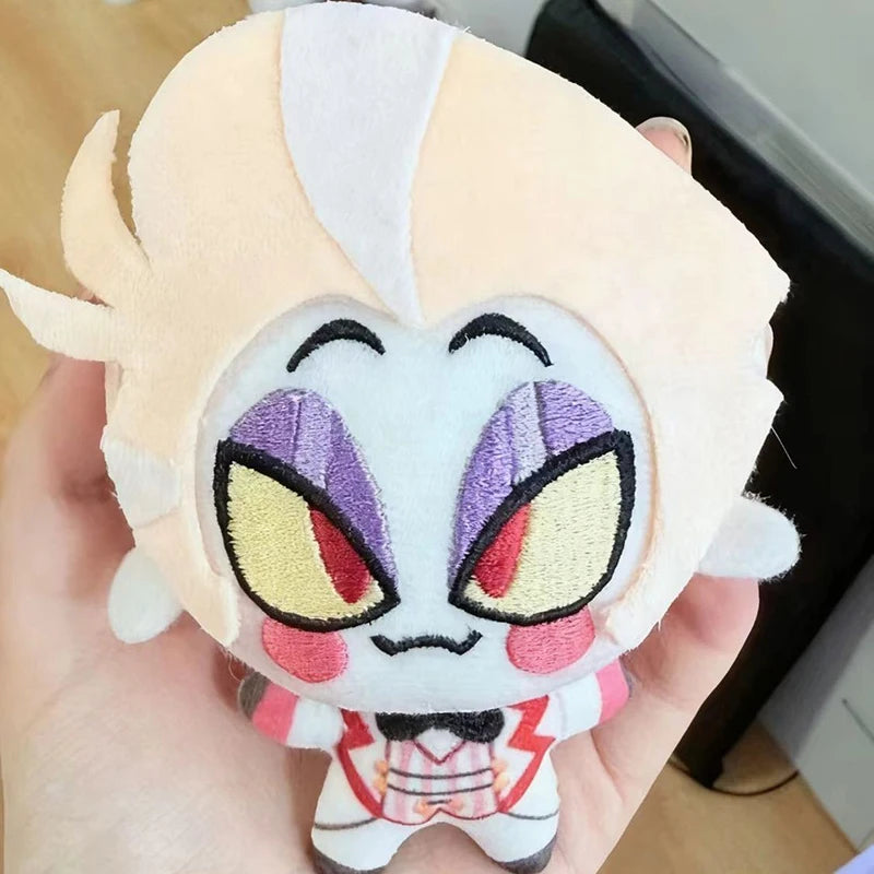 A detailed vox plushie sitting on a modern gaming desk.