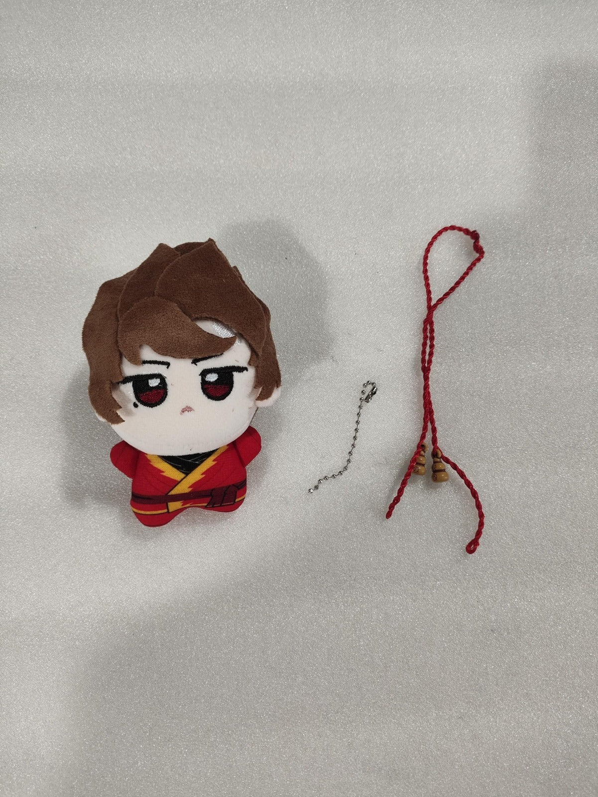 A handmade fan art plush toy of Kai, the red fire ninja from the block adventure series, featuring soft cotton filling and a compact size.