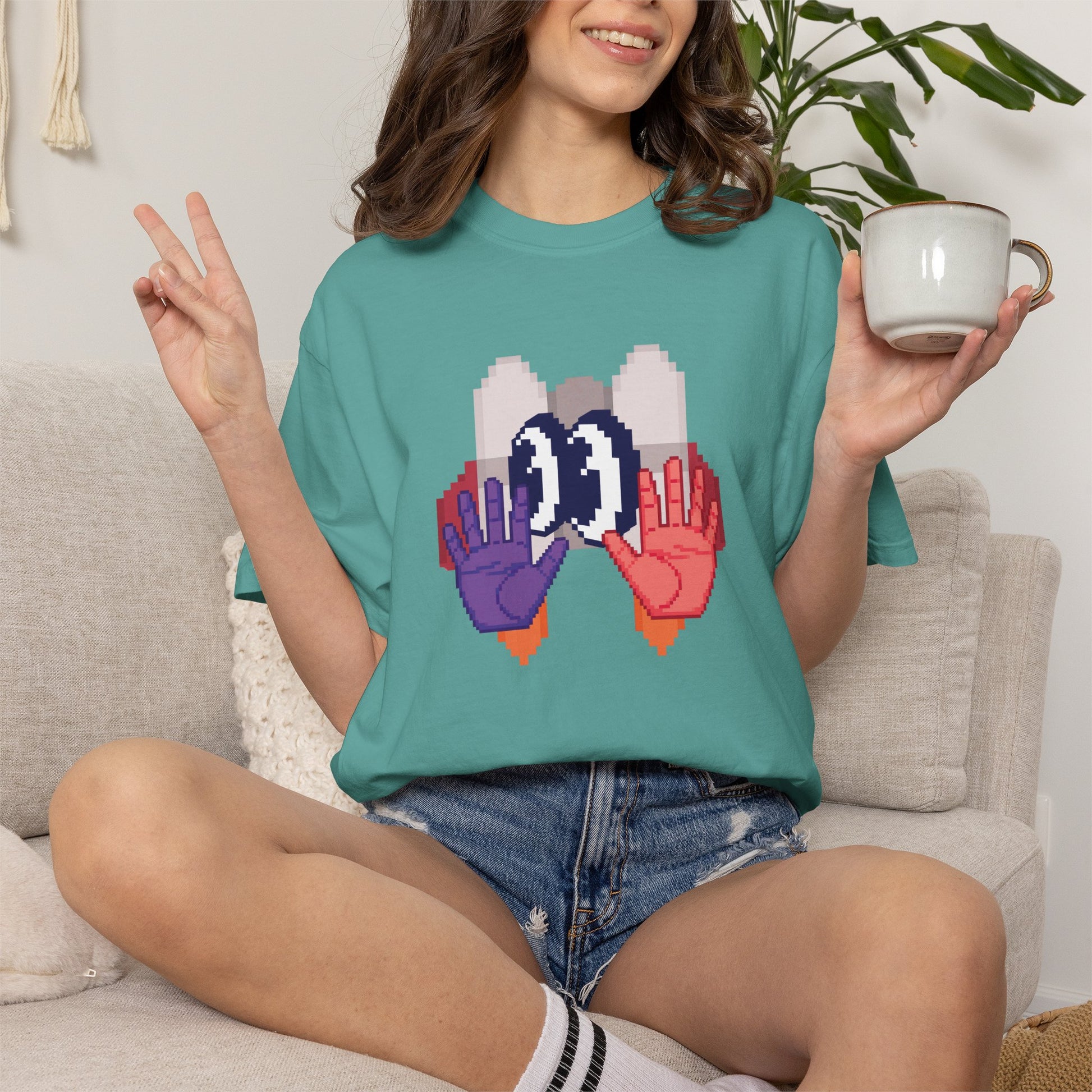 A high-quality product shot features a garment-dyed Comfort Colors 1717 t-shirt in a soft, washed-out tone.