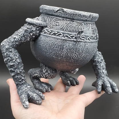 A resin statue of the Elden Ring character Iron Fist Alexander, sculpted as a hollow planter with a wide opening for small plants.