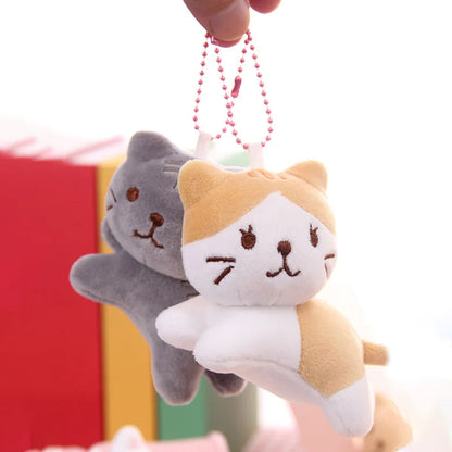 All five tilt-head cat plush keychain variants side by side, Bicolor Ginger, Tuxedo, Striped Ginger, Snow White, Grey Tabby
