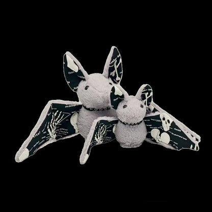 Anatomical bat toy with skeleton wing print glowing in low light