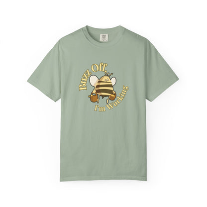 Apiarist humor shirt worn outdoors near wooden beehives in morning light