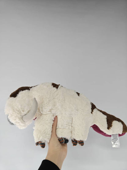 Appa_sky_bison_plushie_standing_against_a_clean_white_background.supplier_photo