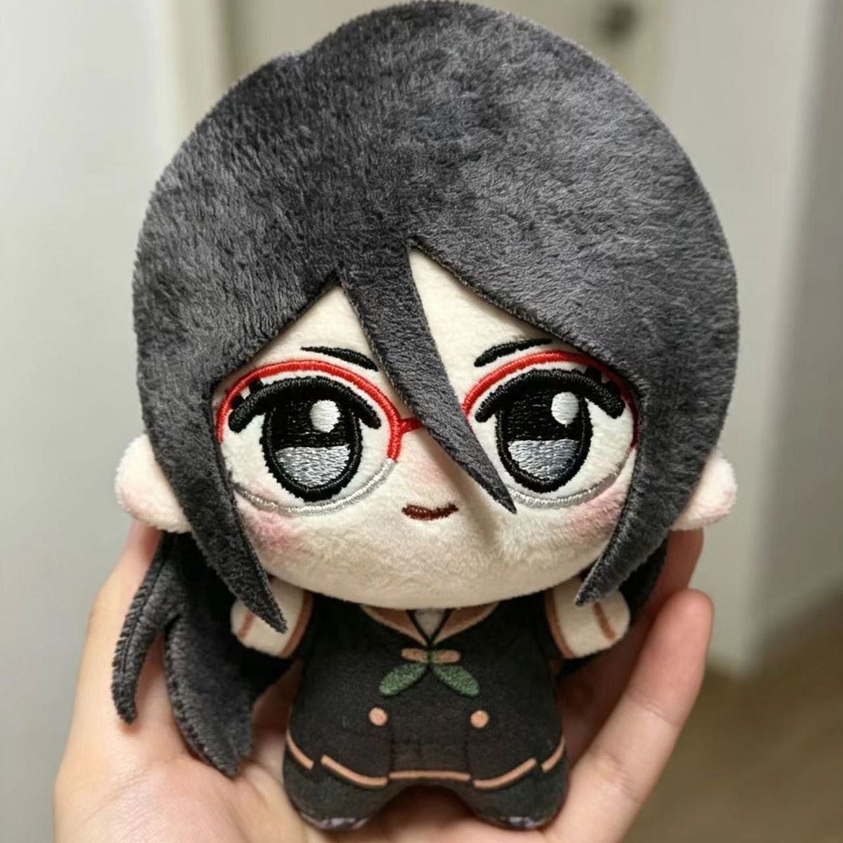 Asuka stuffed toy front view showing embroidered facial detail and signature glasses