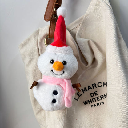 Bag charm keychain plush snowman clipped to backpack zipper lifestyle photo