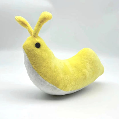 Banana slug plush toy in hand for scale 20cm size reference