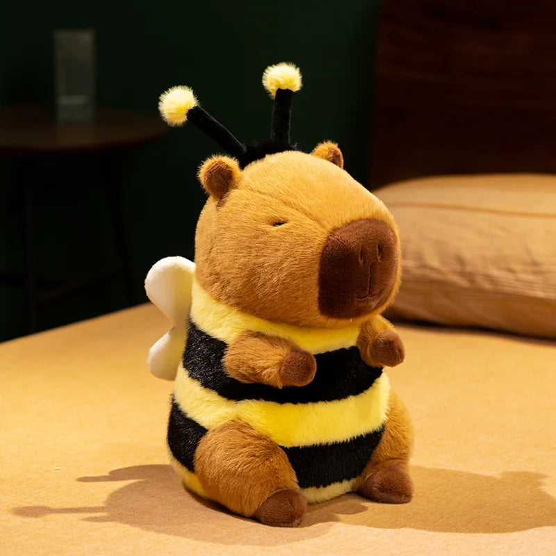Bee capybara plush toy in 33cm size sitting upright, wearing a yellow and black bumblebee costume with rounded wings and curly antennae