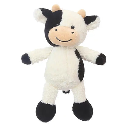 Black and white cow plush shown in a childs hands for size reference