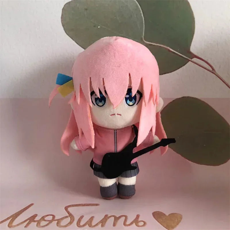 Bocchi plushie 20cm next to hand for scale comparison