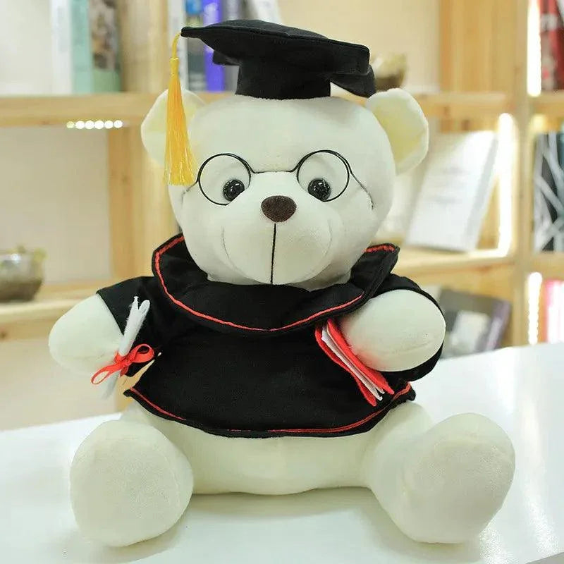 Brown graduate bear plush held by graduate during college graduation celebration
