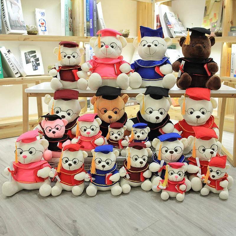 Brown graduate bear plush sitting with graduation sash and rolled diploma ribbon
