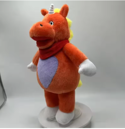 Buddy the Unicorn horror collectible plush displayed on a shelf alongside cult movie memorabilia