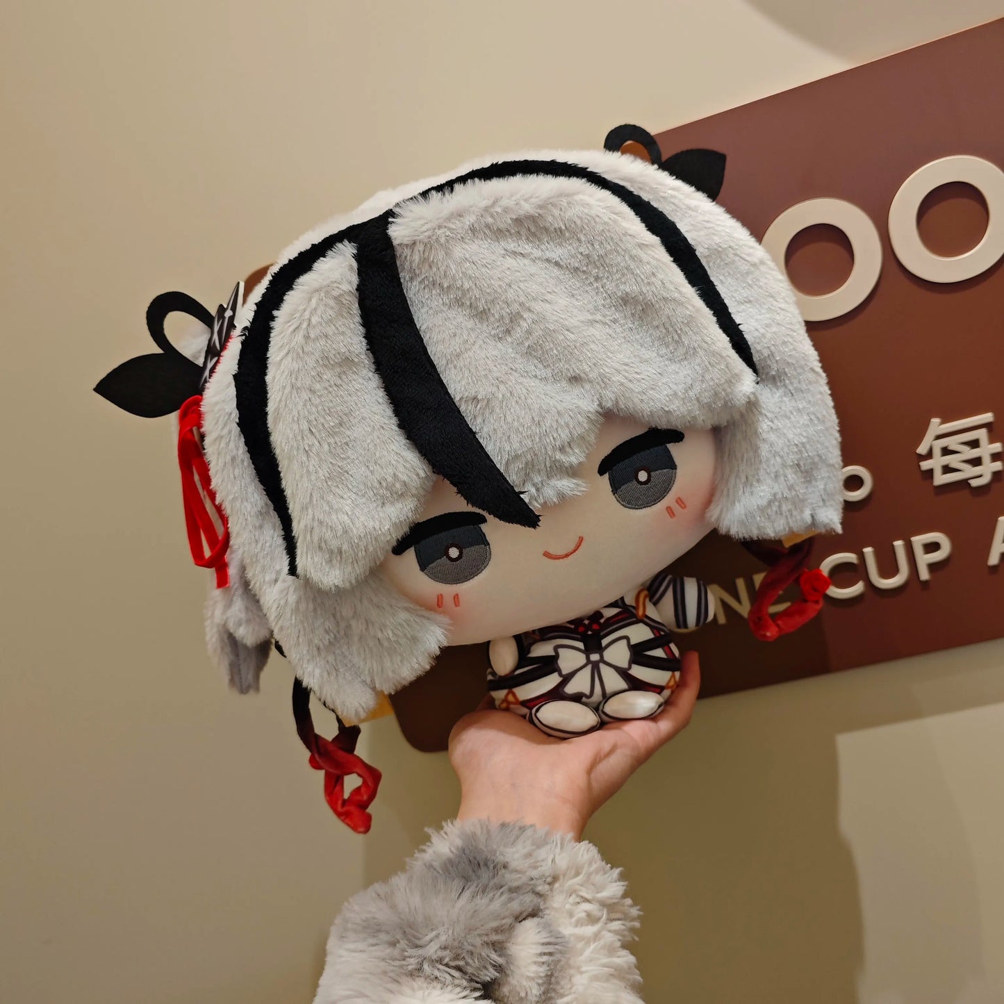Camellya fan plush toy displayed on gaming shelf