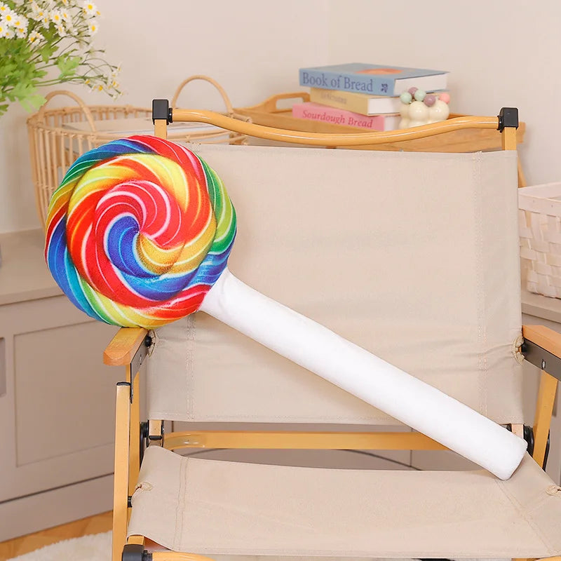 Candy themed bedroom decor corner featuring giant kawaii lollipop plushie with neon accents