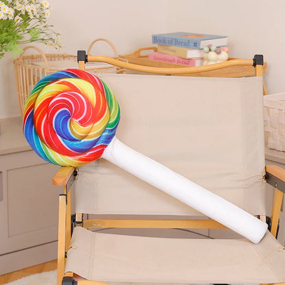 Candy themed bedroom decor corner featuring giant kawaii lollipop plushie with neon accents