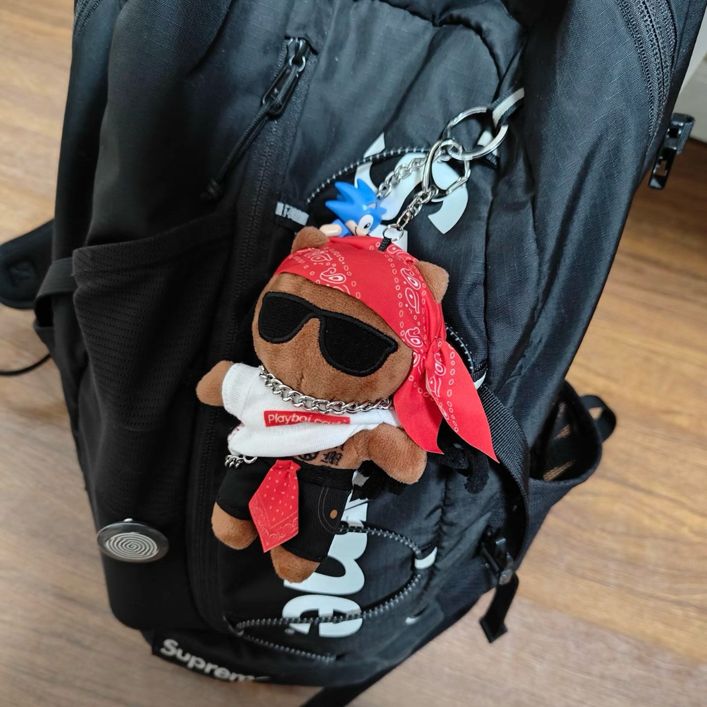 Carti keychain attached to backpack zipper streetwear accessory
