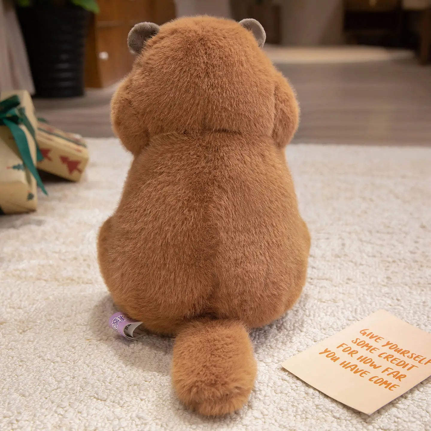 Cartoon groundhog plush sitting upright in classic marmot alert pose