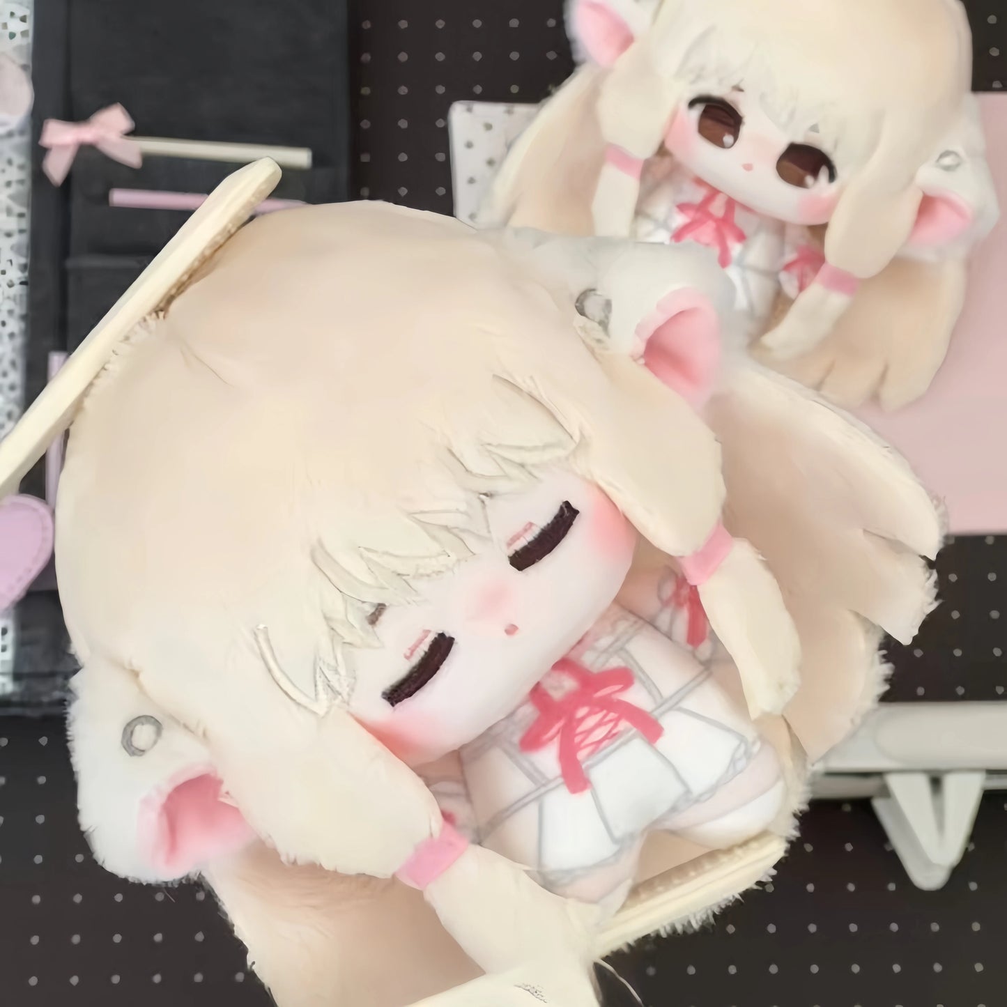 Chi plush displayed on desk beside other CLAMP anime collectible figures