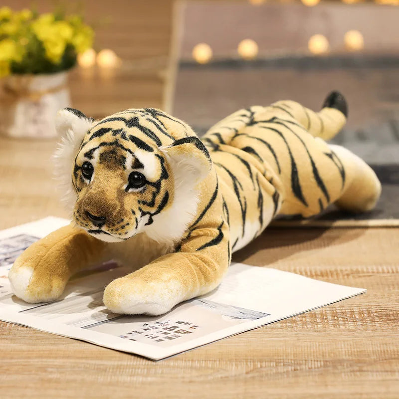 Child holding a large realistic tiger cub stuffed animal as a hugging plush pillow