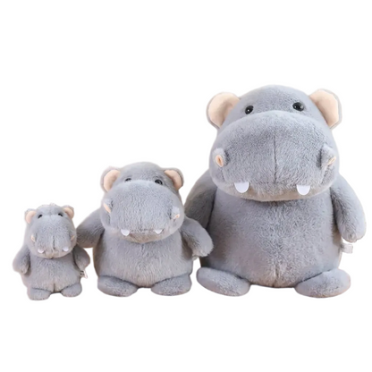Chonky grey hippo plushie sitting on a white shelf, round and ultra-soft handmade stuffed toy
