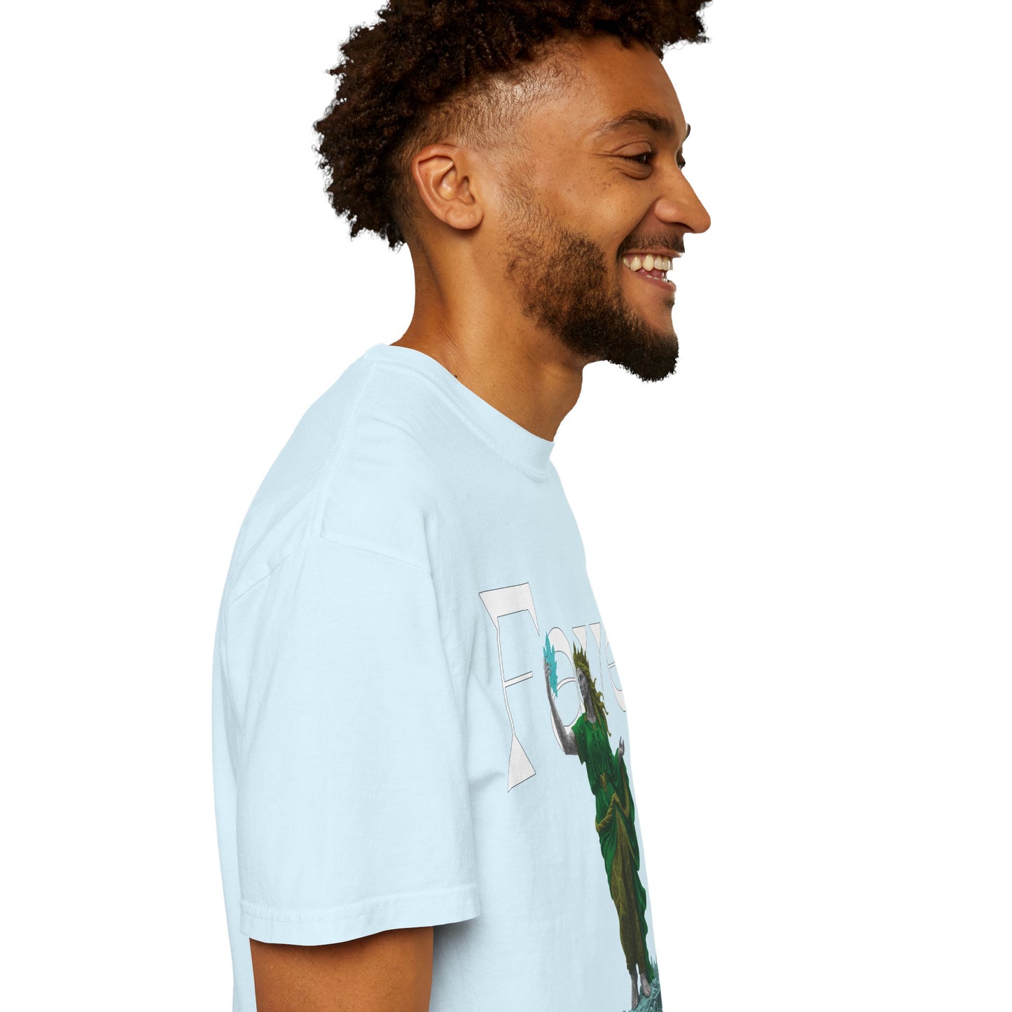 Classical statue tee hanging against a leafy outdoor backdrop
