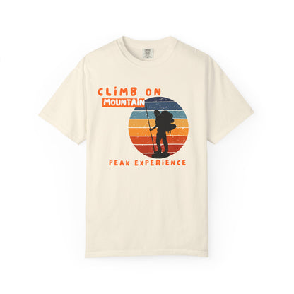 Climbing adventure graphic tee featuring sunset layered mountain peaks and bold typography