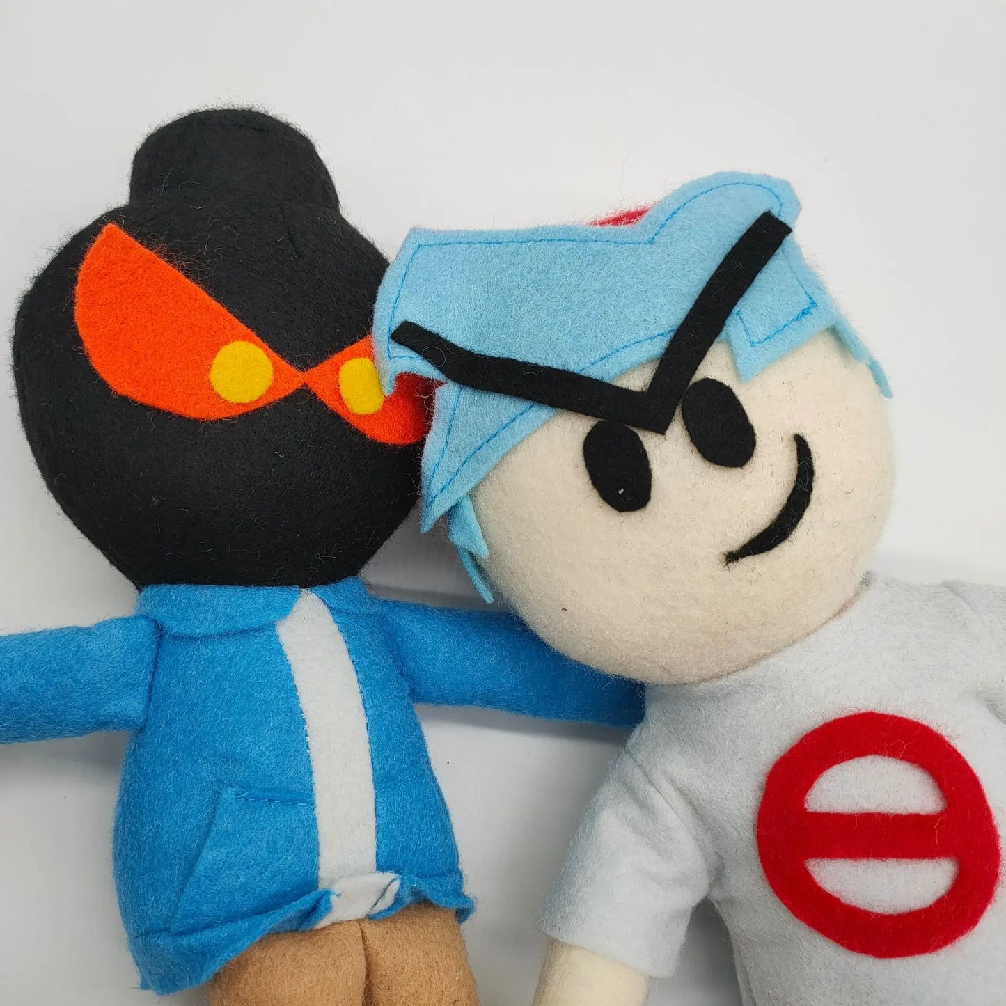 Close-up of Whitty plush face detail, white hair and bomb head design
