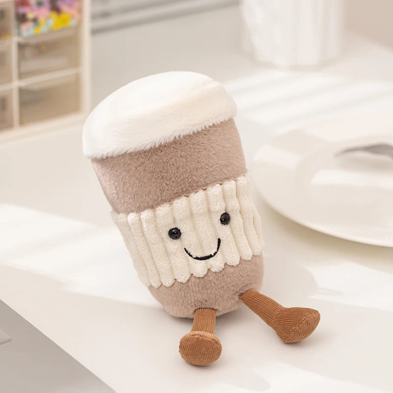 Close-up of embroidered smiling face on kawaii tea cup plushie, handmade collectible