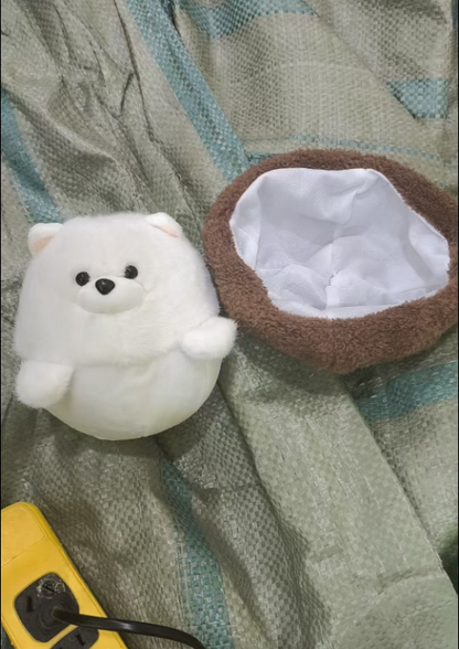 Close-up of fluffy white puppy stuffed animal face with black bead eyes and button nose