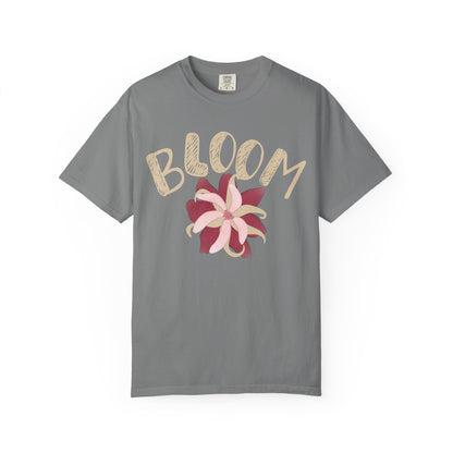 Close-up of hand-lettered BLOOM typography and layered petal motif on vintage floral tee