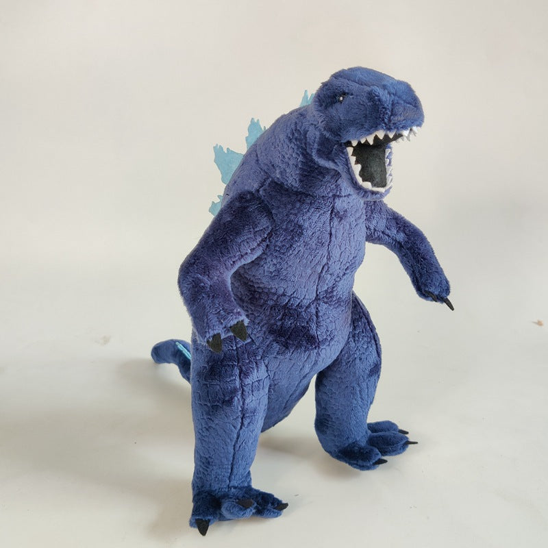 Close-up of handmade giant lizard plush face showing embroidered eyes and open jaw detail
