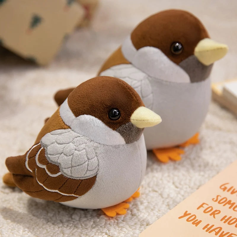Close-up of lifelike stuffed bird plush showing brown cap and wing stitch detail