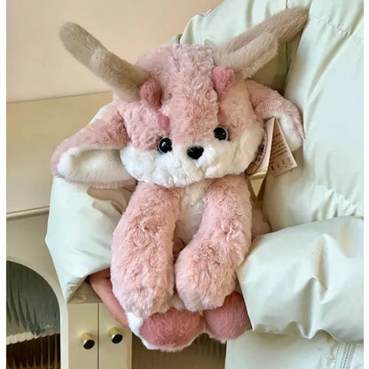 Close-up of long ear dragon plush face, adorable kawaii eyes and pink coloring