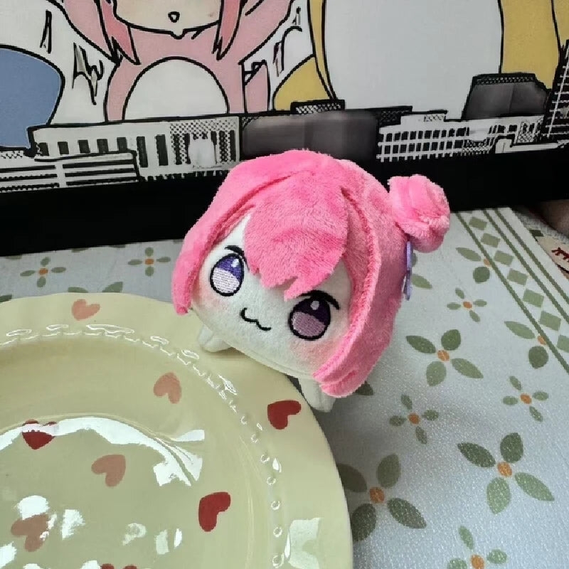 Close-up of pink Doro plushie face showing lavender eyes and grin