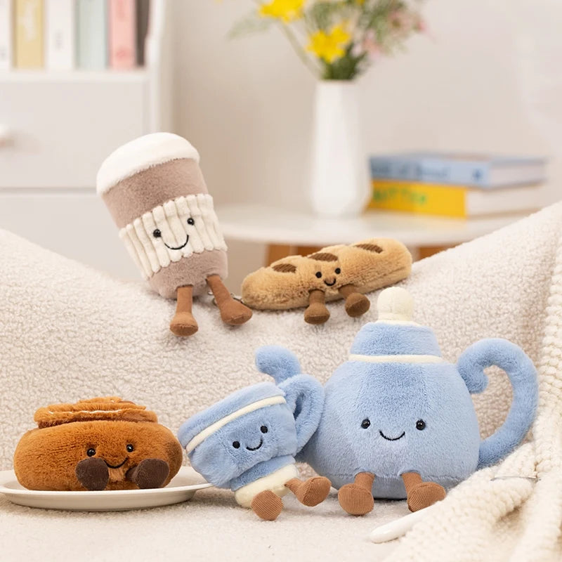 Close-up of tea pot plushie with embroidered smile and corduroy legs, handmade food plushie