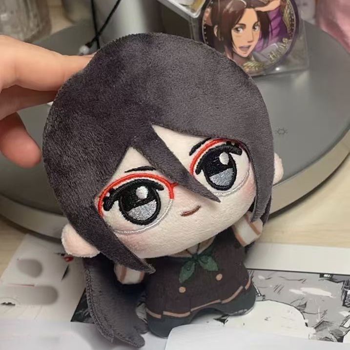 Close up of Asuka Tanaka plushie face detail red framed glasses embroidery
