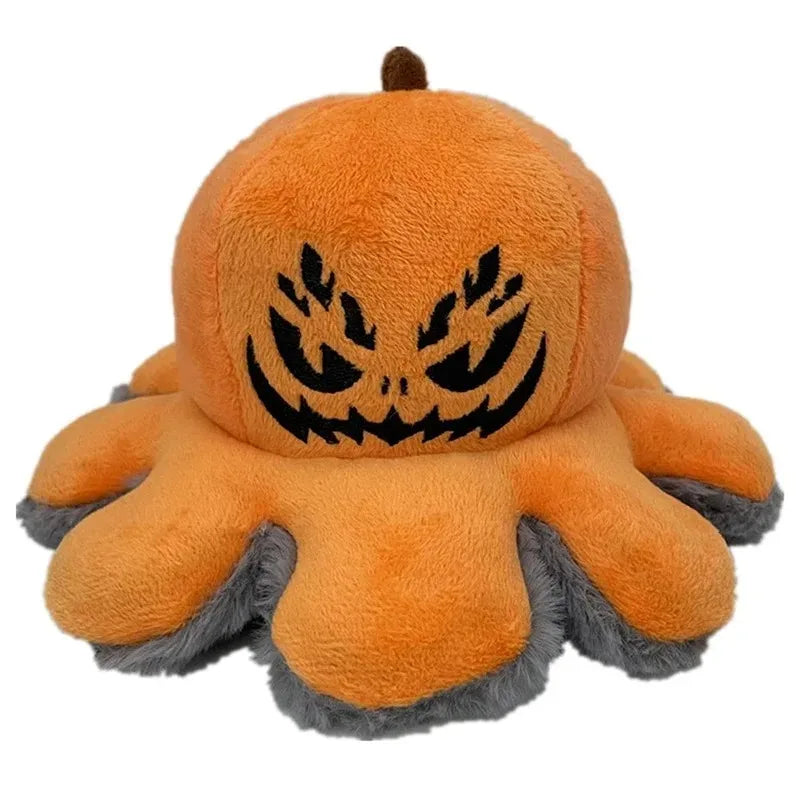 Close up of the embroidered face on the orange pumpkin plush showing stitched angry expression and carved features