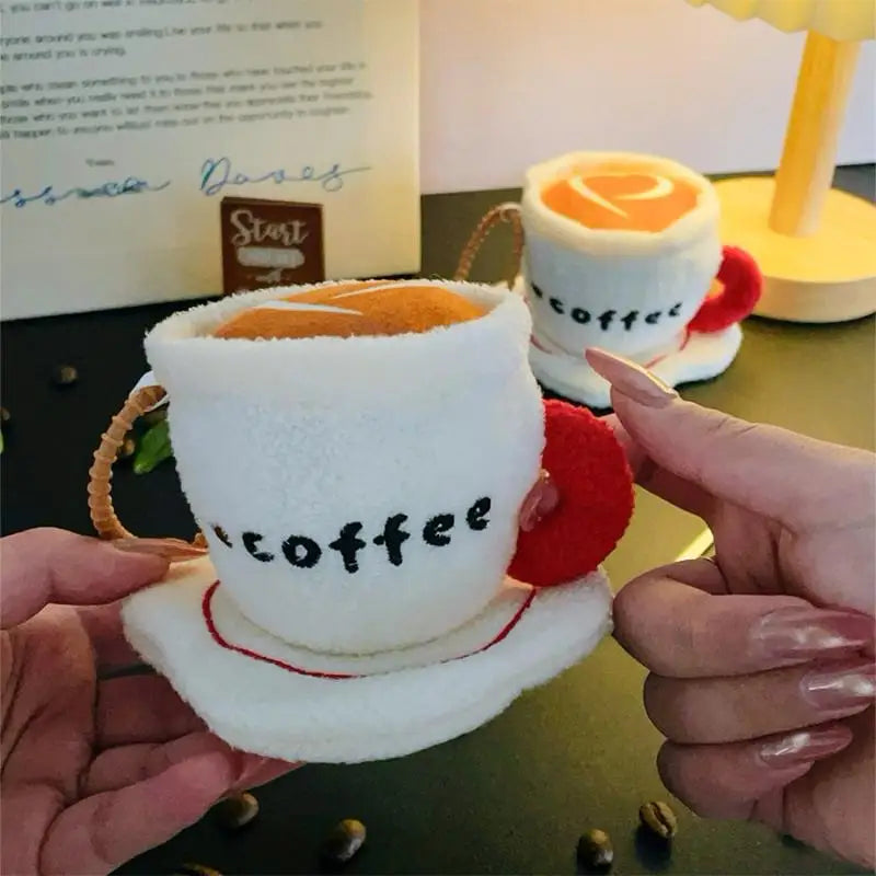 Coffee lover gift flat lay with handmade latte art plush charm and café accessories