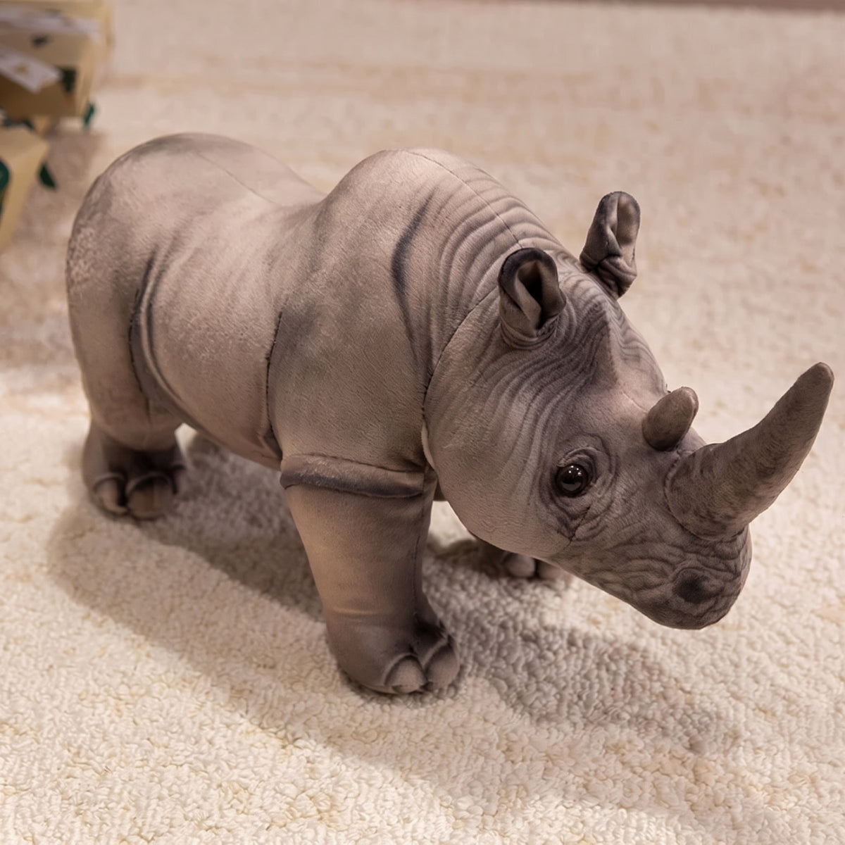 Collectible wildlife plush rhino gift wrapped in kraft paper with ribbon for presentation
