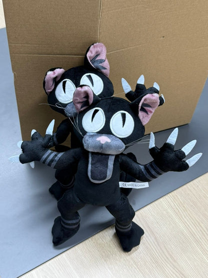 Comparison of 30cm black stuffed cat next to a book.