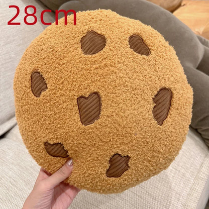 Cookie stuffed toy 10cm pendant size next to a 45cm cookie seat cushion showing size comparison