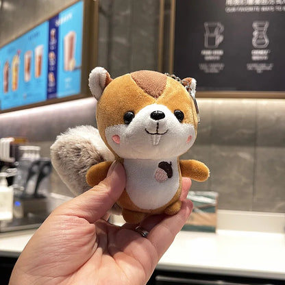 Cottagecore plush keychain squirrel design on mossy surface flatlay
